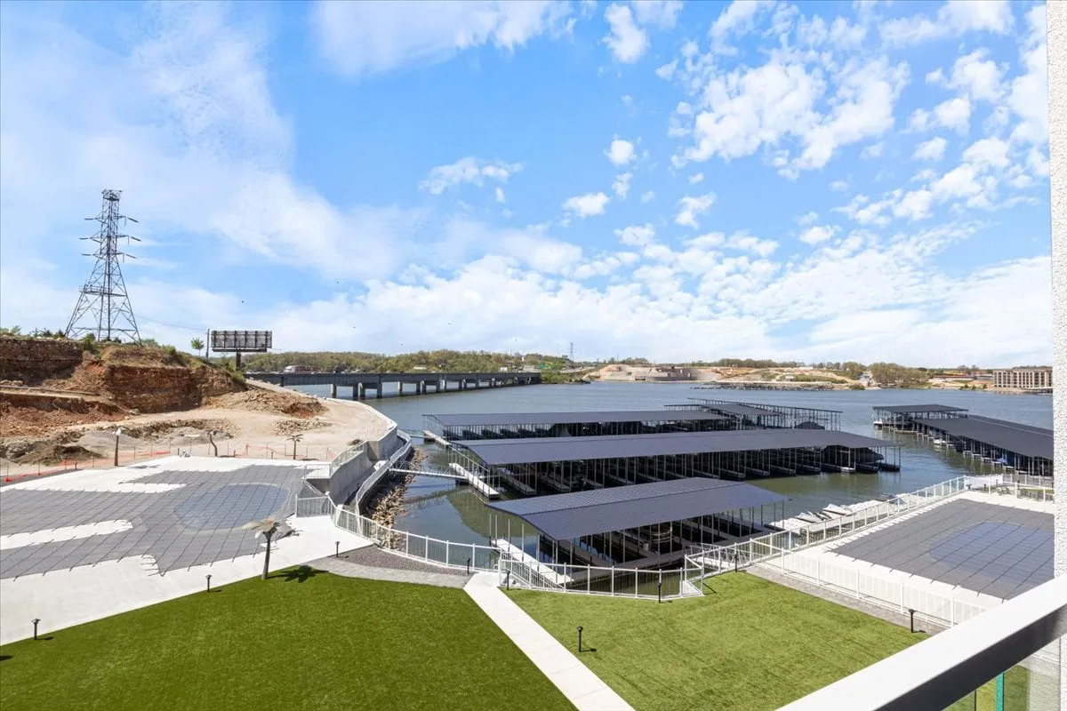 A panoramic view of the lake and marina, with wide open skies and gentle water. The scene evokes outdoor exploration, boating, and the natural beauty that makes lakeside adventures appealing for families.